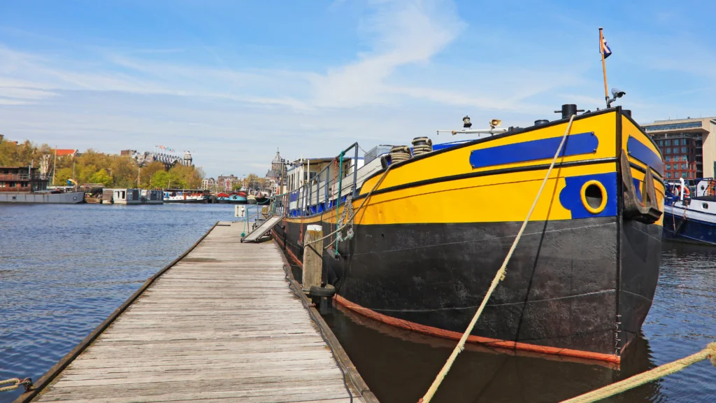 Living on a houseboat_ boat docked at wharf